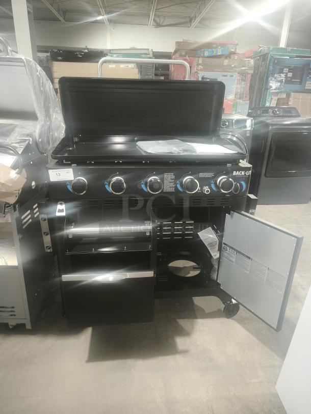 Brand new Pit Boss PB5BGD2 gas griddle with 5 burners and cabinet. Features back-lit controls, storage drawers, and open cabinet door.