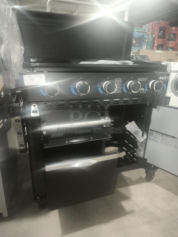 Brand new Pit Boss PB5BGD2 5-burner gas griddle with cabinet. Features control knobs, storage drawer, and side shelves.