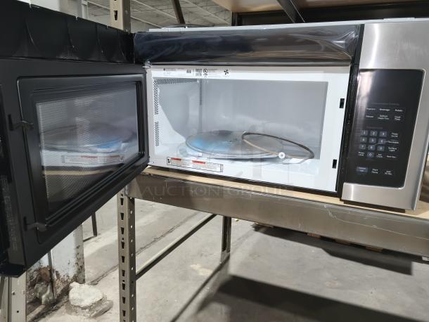 BRAND NEW GE 1.6 cu ft Over-the-Range Microwave JVM3162RJSS, minor scratches, stainless steel, open door view, control panel visible.