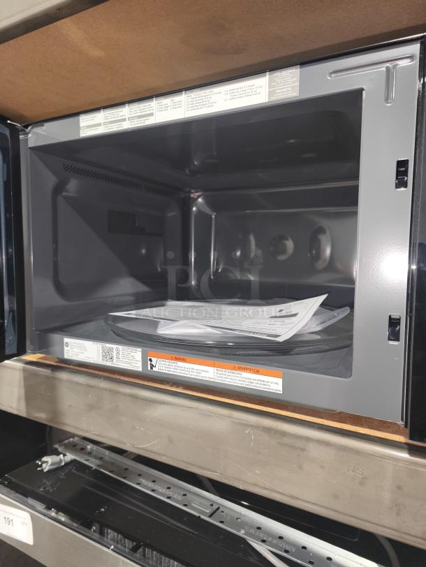 Brand new scratch and dent GE Profile 2.2 Cu. Ft. built-in sensor microwave oven, model PCWK22U1WBB, open view inside.