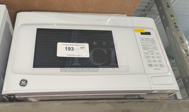 BRAND NEW GE 1.1 Cu. Ft. Countertop Microwave, Model GCST11N1W1WW, scratch and dent condition, visible control panel.