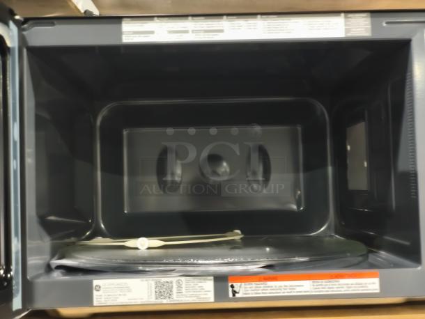 BRAND NEW GE Profile 2.2 cu ft Built-In Sensor Microwave Oven, Model PCWK22U1WDD. Scratch and Dent condition. Interior view.