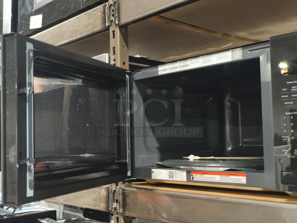 BRAND NEW SCRATCH AND DENT GE Profile 2.2 cu ft built-in sensor microwave oven, Model PCWK22U1WDD, open door view, interior features.