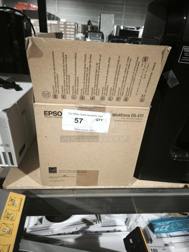Brand new Epson DS-410 sheetfed scanner in box, supports 600 dpi, 48-bit color, duplex scanning, USB connectivity.