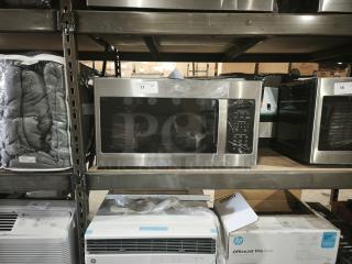 BRAND NEW SCRATCH AND DENT GE 1.7 cu ft Over-the-Range Sensor Microwave Oven, Model JVM6175SK6SS, on warehouse shelf.