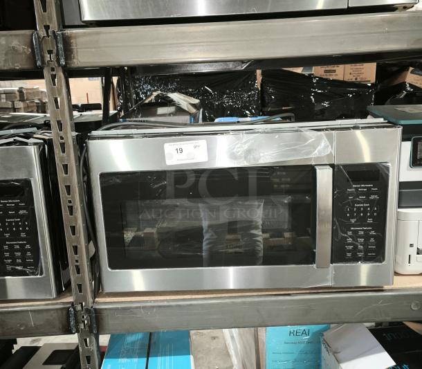 BRAND NEW GE 1.7 cu ft Over-the-Range Sensor Microwave Oven, Model JVM6175SK6SS. Minor scratches and dents visible.