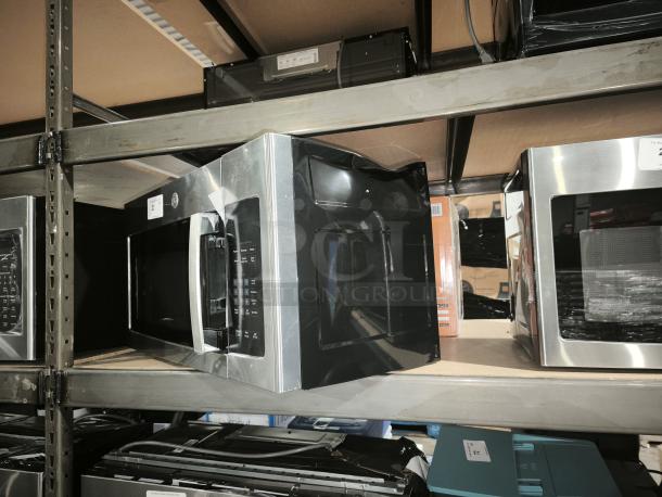 BRAND NEW GE 1.6 cu ft Over-the-Range Microwave Oven, Model PVM9005SJ8SS. Scratch and dent condition; visible minor dents.