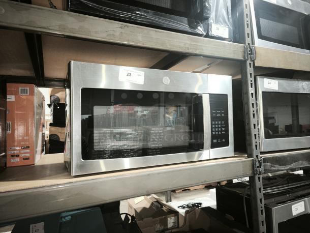 BRAND NEW SCRATCH AND DENT GE 1.6 cu ft Over-the-Range Microwave Oven, model PVM9005SJ8SS, stainless steel, on shelf.
