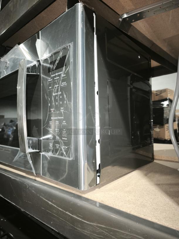 BRAND NEW GE 1.7 cu ft Over-the-Range Microwave, Model JVM6175SK6SS, with visible scratches. Packed in protective wrap.