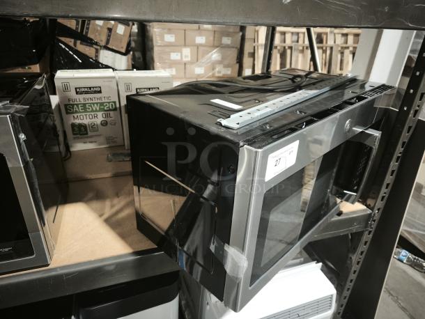 Brand new GE 1.6 cu ft Over-the-Range Microwave, model JVM3162RJ6SS. Scratch and dent condition, side damage visible.
