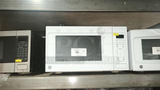 Brand new GE 1.1 Cu. Ft. Countertop Microwave, Model GCST11N1WWW. Scratch and dent unit with keypad and turntable.