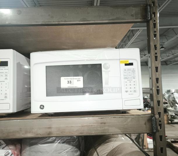 BRAND NEW GE 1.1 Cu. Ft. Countertop Microwave Oven, model GCST11N1W1WW, scratch and dent condition, white, keypad control.