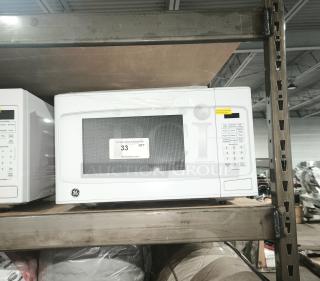 BRAND NEW GE 1.1 Cu. Ft. Countertop Microwave Oven, model GCST11N1W1WW, scratch and dent condition, white, keypad control.