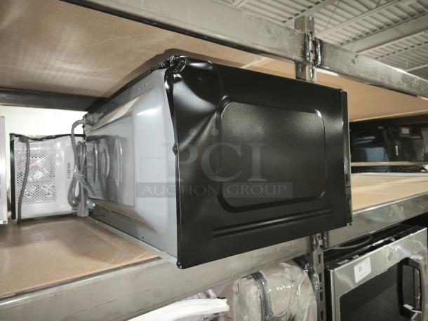 BRAND NEW SCRATCH AND DENT GE Profile 2.2 cu ft built-in sensor microwave model PCWK22U1WDD with dented side panel.