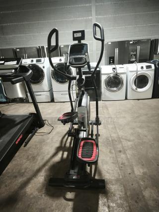 Brand new ProForm CoachLink E9.0 Elliptical, model PFEL59718, in pristine condition, display screen and handlebars visible.