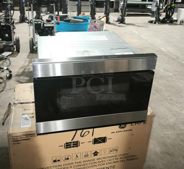 Brand new Sharp Smart Microwave Drawer, model SMD2489ES, stainless steel finish, on shipping box, showcases sleek design.
