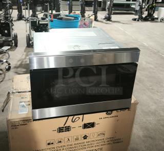 Brand new Sharp Smart Microwave Drawer, model SMD2489ES, stainless steel finish, on shipping box, showcases sleek design.