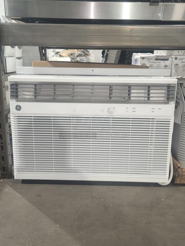 Brand new scratch and dent GE 24,000 BTU smart window air conditioner, model AWCS24WWL, displayed on a shelf.