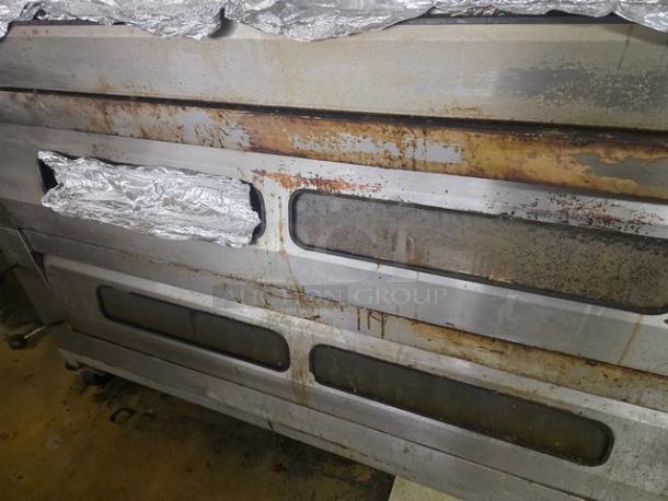 Bakers Aid Ultra Deck Oven (Model BADO-434HC) with 4 decks, 208 3-phase power, on casters. Visible wear and metal tarnish.