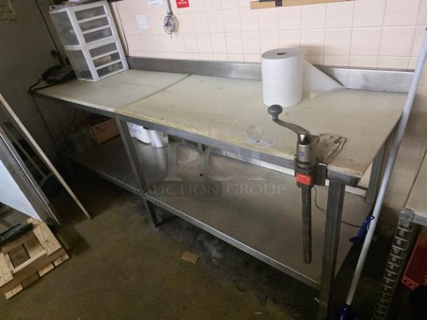 Stainless steel cutting board table with integrated can opener, used condition. Features under-shelf storage and backsplash.