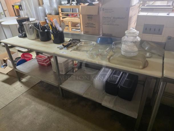 Stainless steel cutting board butcher block table with attached can opener, used condition, sturdy design, ample storage space.