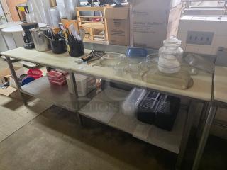 Stainless steel cutting board butcher block table with attached can opener, used condition, sturdy design, ample storage space.