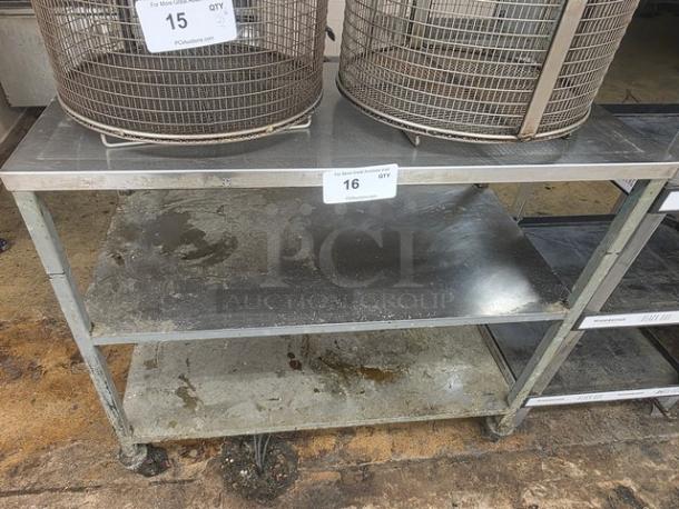 Stainless Steel Cart, three-tier with casters, well-used condition with visible wear. Contents on top not included.