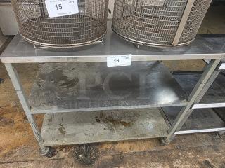 Stainless Steel Cart, three-tier with casters, well-used condition with visible wear. Contents on top not included.