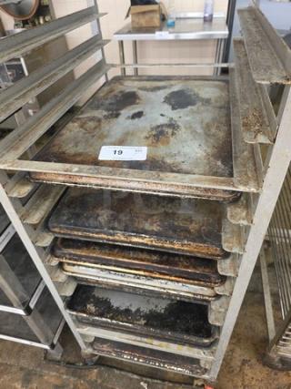 Lot of 10 full-size sheet pans, used condition, visible wear and discoloration; rack not included.