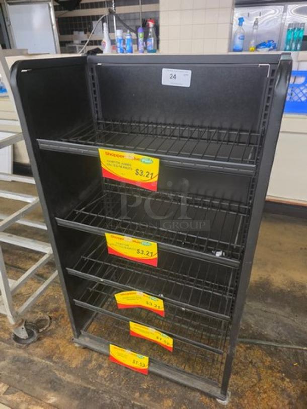 Black metal shelving unit with five wire shelves, item tag "24," sale labels indicating $3.21. Used condition.