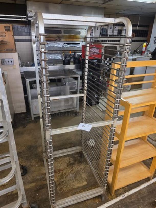 Nesting bun pan rack on casters, metal, tall design, holds multiple pans, labeled "27," durable for bakery use.