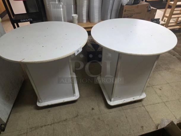 Lot of 2 round pedestal tables, white, moderate wear, solid base, ideal for various settings, approximate height 30 inches.