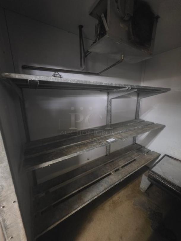 Lot of 2 wall-mountable shelving units for walk-in cooler or freezer, metal construction, good condition, buyer removal required.