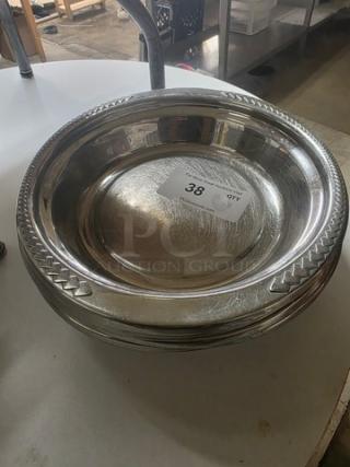 Lot of 8 stainless steel food pans, round with decorative edges, item labeled "38", in good condition, ideal for serving.
