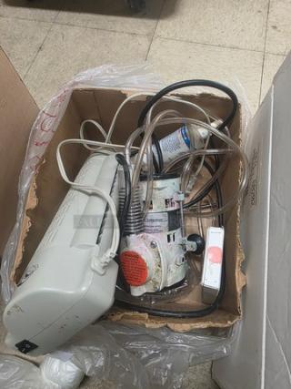 Box containing a laminator and AB-CB model air compressor, both appear used, cords and hoses visible, sold together.