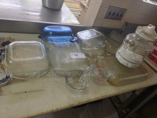 Lot of miscellaneous glass containers including Pyrex measuring cups, square baking dishes, and a large jar. Good condition.