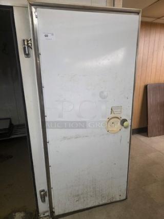 Walk-in cooler door with hardware, white surface, visible latch and handle. Buyer must remove. Good condition.