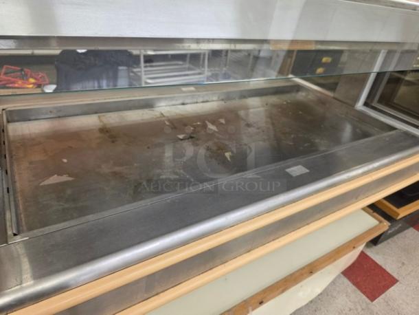 Henny Penny HMI-105 Hot Food Case in used condition. Stainless steel exterior, 120/208V, 60 Hz, 1 PH. Glass display.
