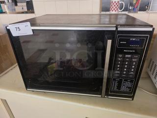 Kenmore microwave with digital keypad, black and stainless steel finish. Visible wear and auction tag labeled "75".