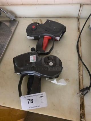 Lot of 2 Monarch 1151 label guns in used condition, featuring ergonomic handles. Auction tag shows "QTY 2, 78".
