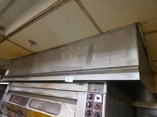 Commercial exhaust hood, stainless steel, above cooking equipment. Some visible wear. Buyer removal required. Item number 80.