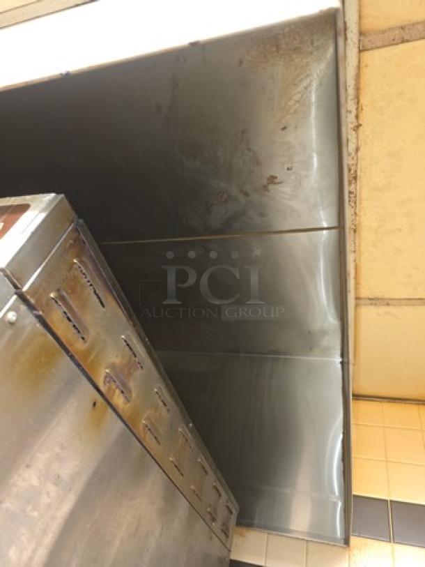 Commercial stainless steel exhaust hood, wall-mounted, visible wear and discoloration, buyer responsible for removal.