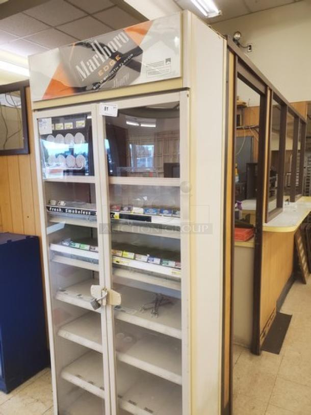 Marlboro cigarette display case, glass doors, multiple shelves, Marlboro Edge branding on top, used condition.