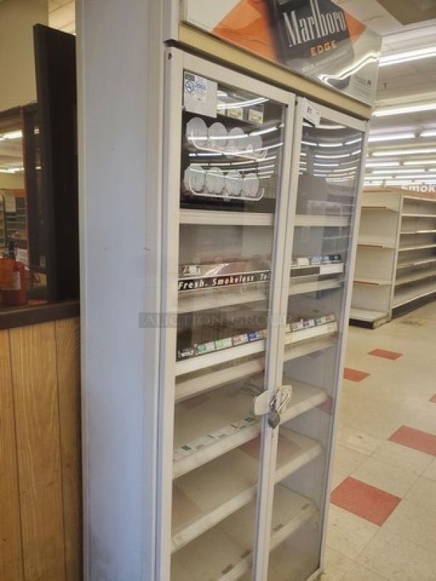 Cigarette display case with glass doors, Marlboro branding, lockable, used condition, multiple shelves, visible tobacco products.