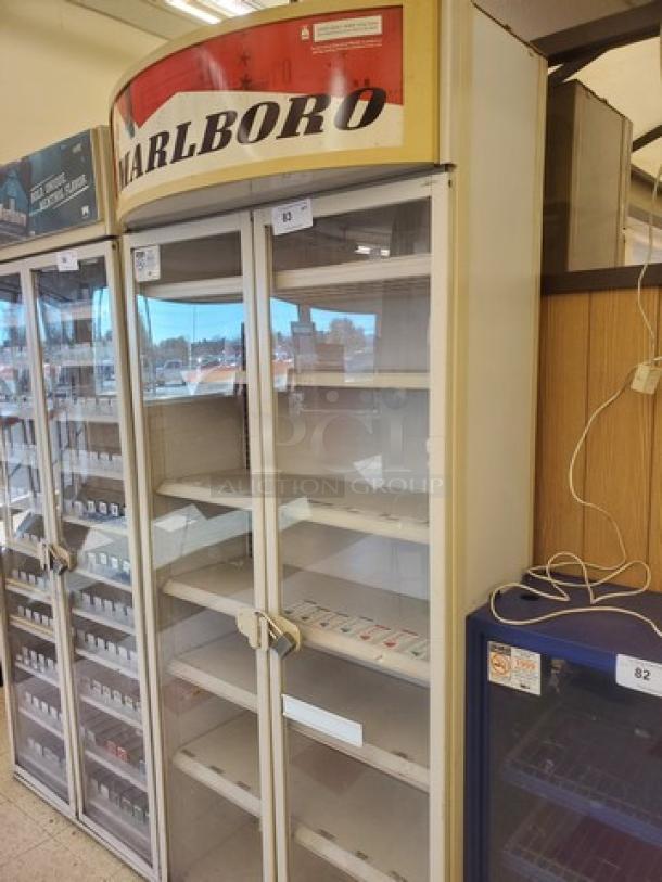 Marlboro cigarette display case, glass doors, multiple shelves, used condition, branded signage on top, ideal for retail use.