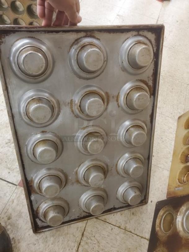 Lot of 8 vintage muffin/cupcake baking pans, well-used with visible wear and patina, metal construction, 12 cups each.