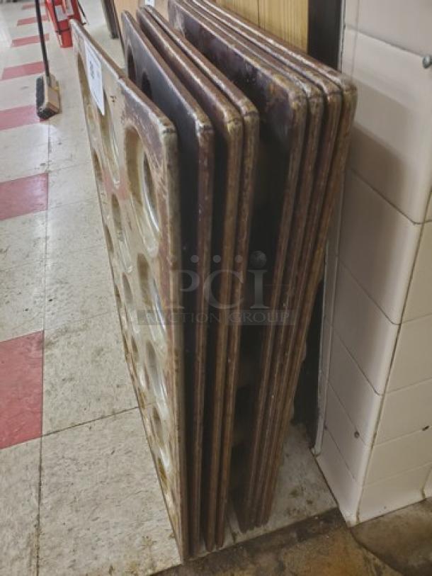 Lot of 8 muffin/cupcake baking pans, used condition, stacked vertically. Some wear visible, suitable for bulk baking.