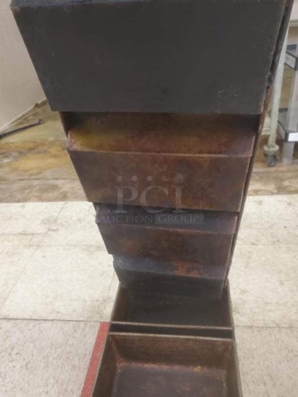 Lot of five vintage 4-compartment loaf pans stacked. Used condition with visible wear and rust. Ideal for baking enthusiasts or collectors.