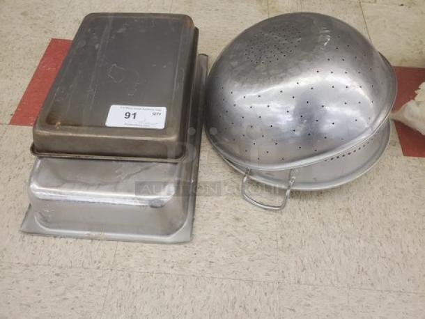 One lot of miscellaneous food pans and perforated bowls, metal, used condition, includes rectangular and round shapes.