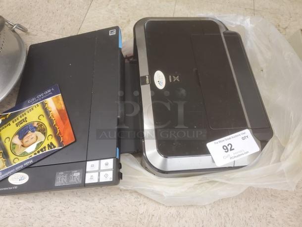 One lot including an Epson Perfection V30 scanner and Canon PIXMA iP4820 printer. Both items in used condition, auction label visible.